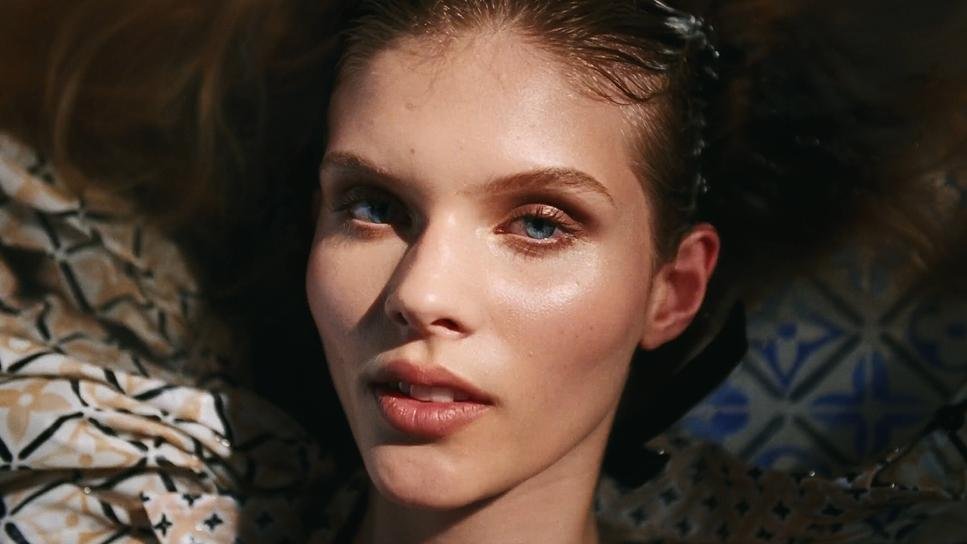 Close-up of a face lying on patterned fabric